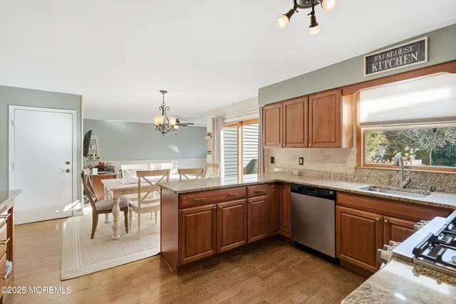 a kitchen with a sink table and chairs