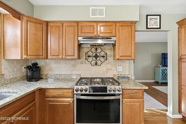 a kitchen with a stove and a sink
