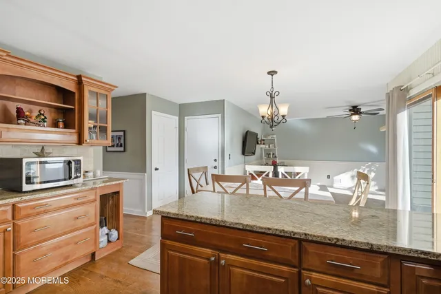 a kitchen with granite countertop a sink a stove and cabinets