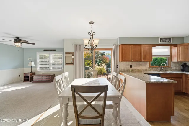 a kitchen with a table chairs sink and cabinets