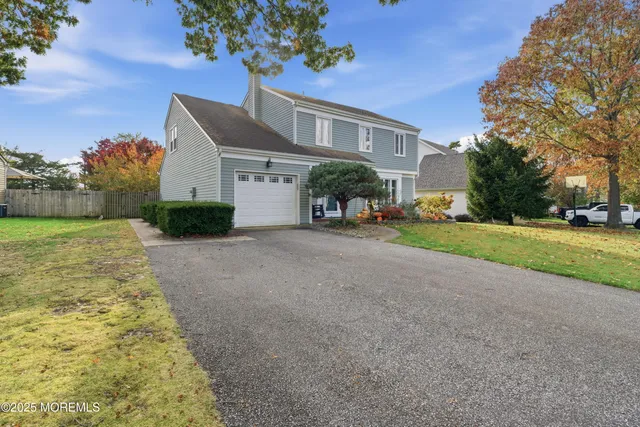 a view of a house with a yard and pathway