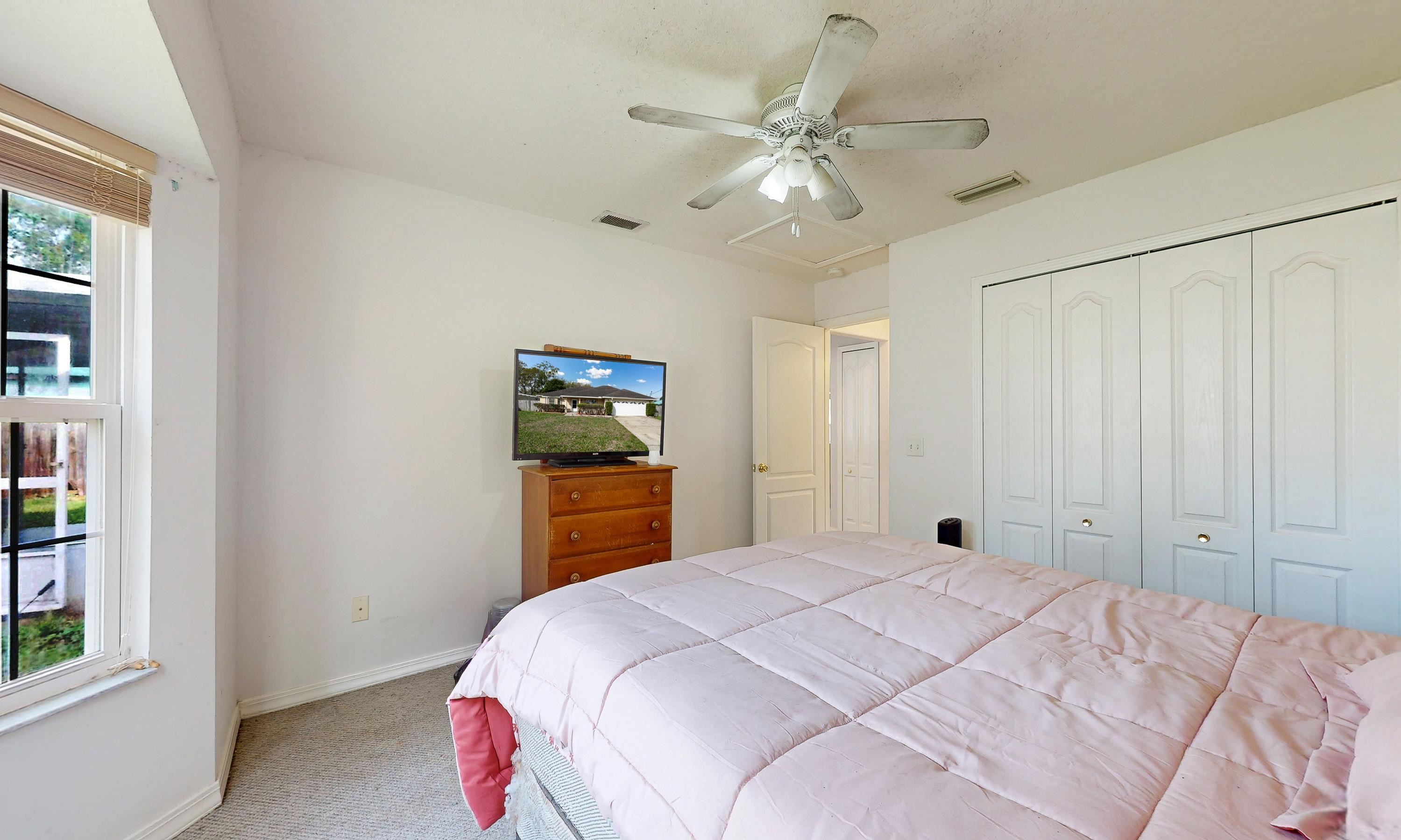 330 Segovia Road St. Augustine, FL 32086 - Photo 21 of 52 a bedroom with a large bed and a chandelier