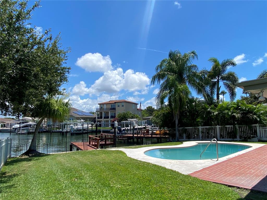 a view of a swimming pool with a table and chairs