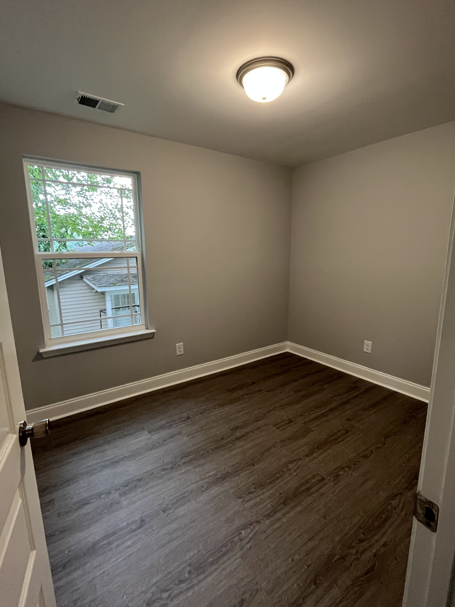 521 South Highland Street Springfield, TN 37172 - Photo 10 of 11 an empty room with wooden floor and windows