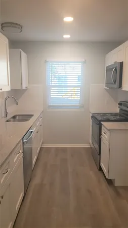 a kitchen with a sink stove and cabinets