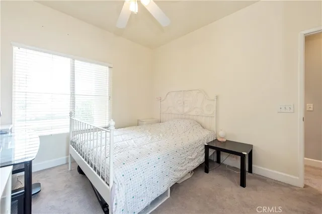 a bed sitting in a bedroom next to a window