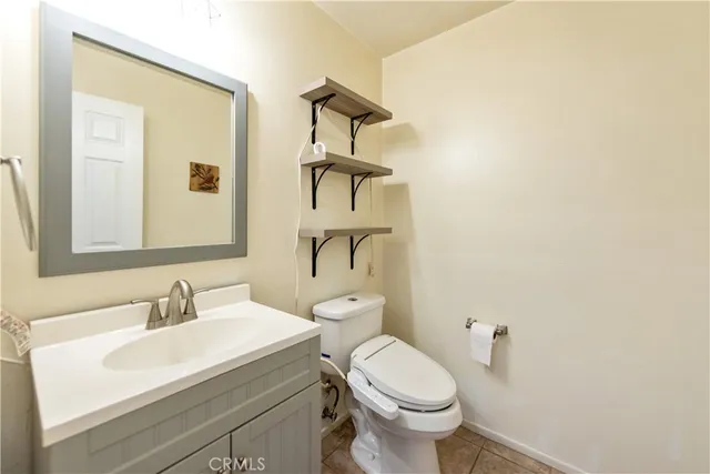 a bathroom with a sink a toilet and mirror