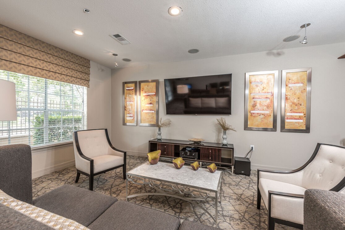 5800 Woodway Drive, Unit 228 Houston, TX 77057 - Photo 17 of 23 a living room with furniture a flat screen tv and large window