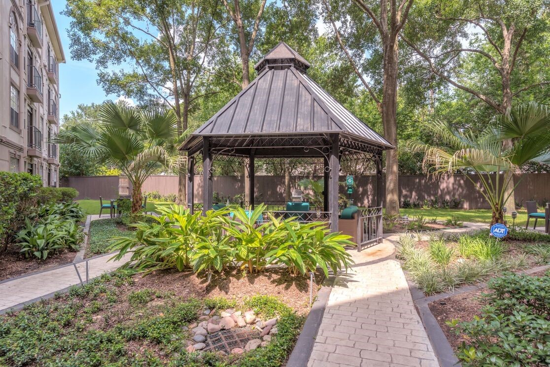 5800 Woodway Drive, Unit 228 Houston, TX 77057 - Photo 3 of 23 a front view of a house with garden