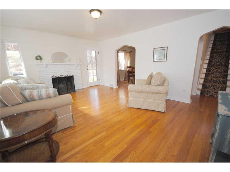 3304 Comanche Road Upper St. Clair, PA 15241 - Photo 2 of 20 Living Room. View of Open Living Room as you enter home--open & airy. Gleaming hardwood floors. Log-burning fireplace. Door opens to pretty patio.