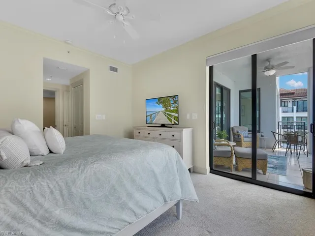 a bedroom with a bed and large mirror