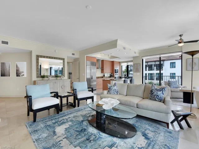 a living room with furniture dining area and a rug