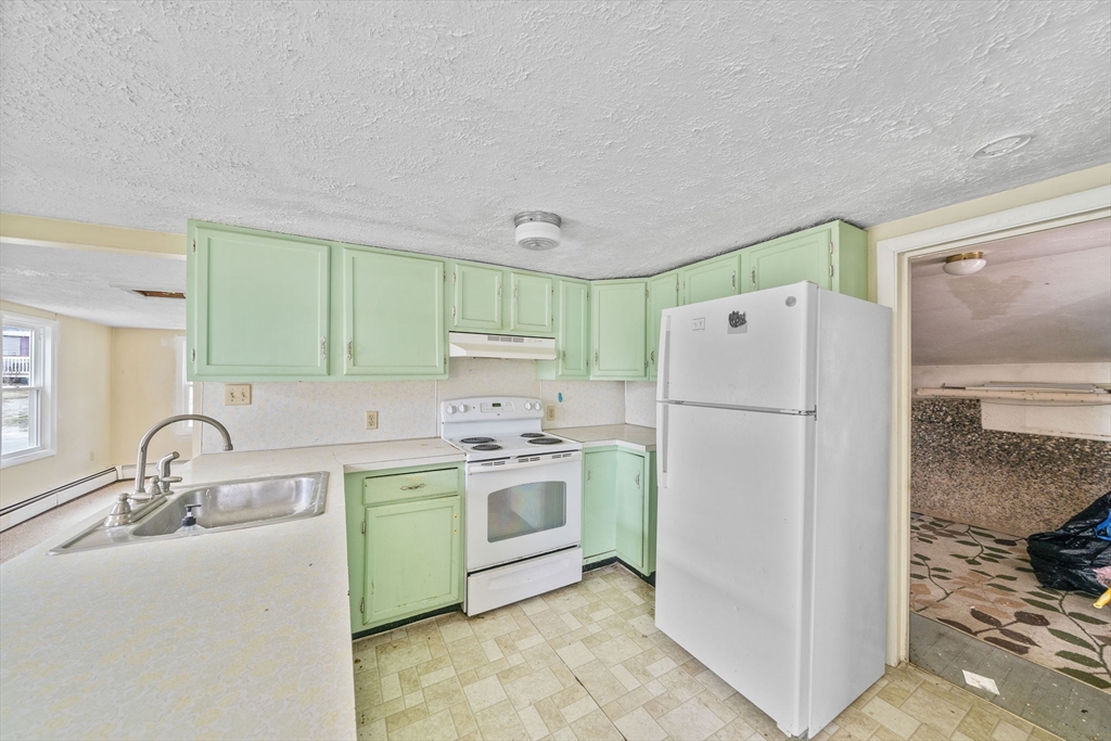 3 Short Neck Road Wareham, MA 02532 - Photo 6 of 24 a kitchen with a sink a refrigerator and a stove