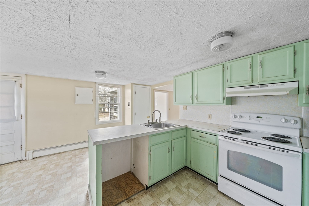 3 Short Neck Road Wareham, MA 02532 - Photo 7 of 24 a kitchen with a sink stove and cabinets