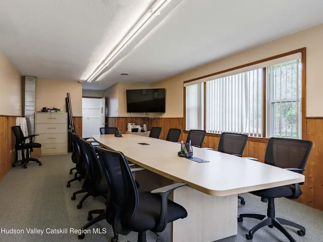 a living room with furniture a flat screen tv and a table