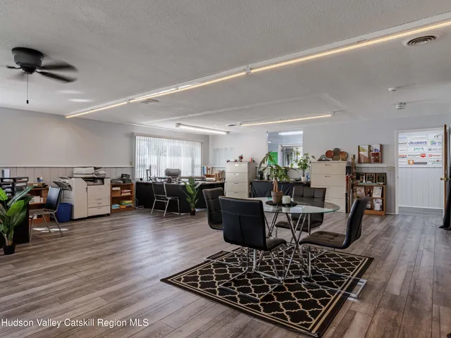 a living room with lots of furniture and kitchen view