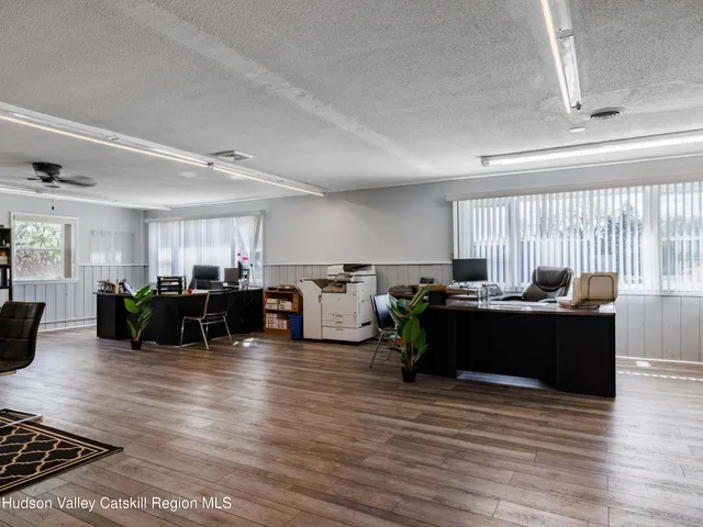 a dining room with furniture and wooden floor
