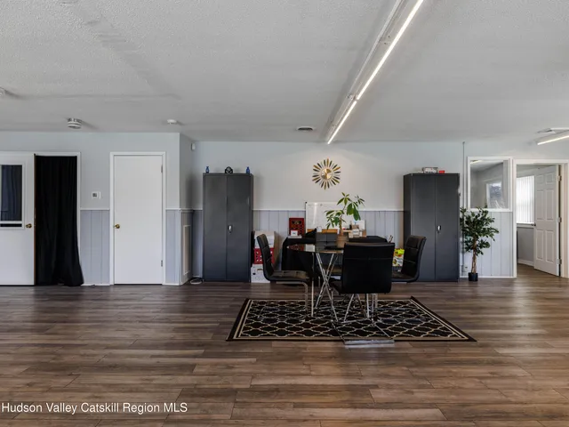a view of a workspace with furniture and a window