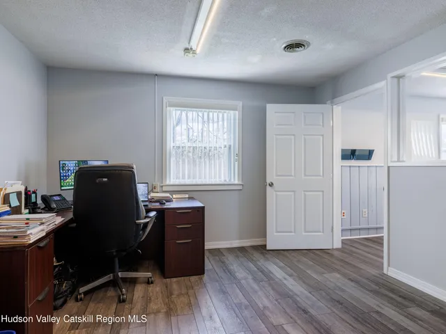 a view of a hallway view with wooden floor and furniture