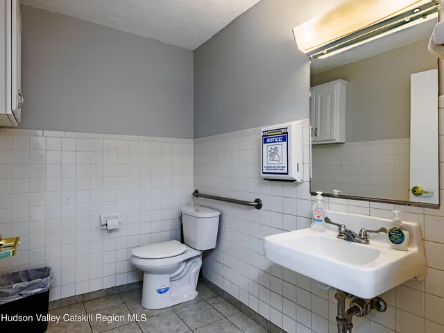a bathroom with a sink toilet and a mirror