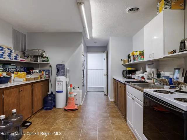 a kitchen with refrigerator and cabinets