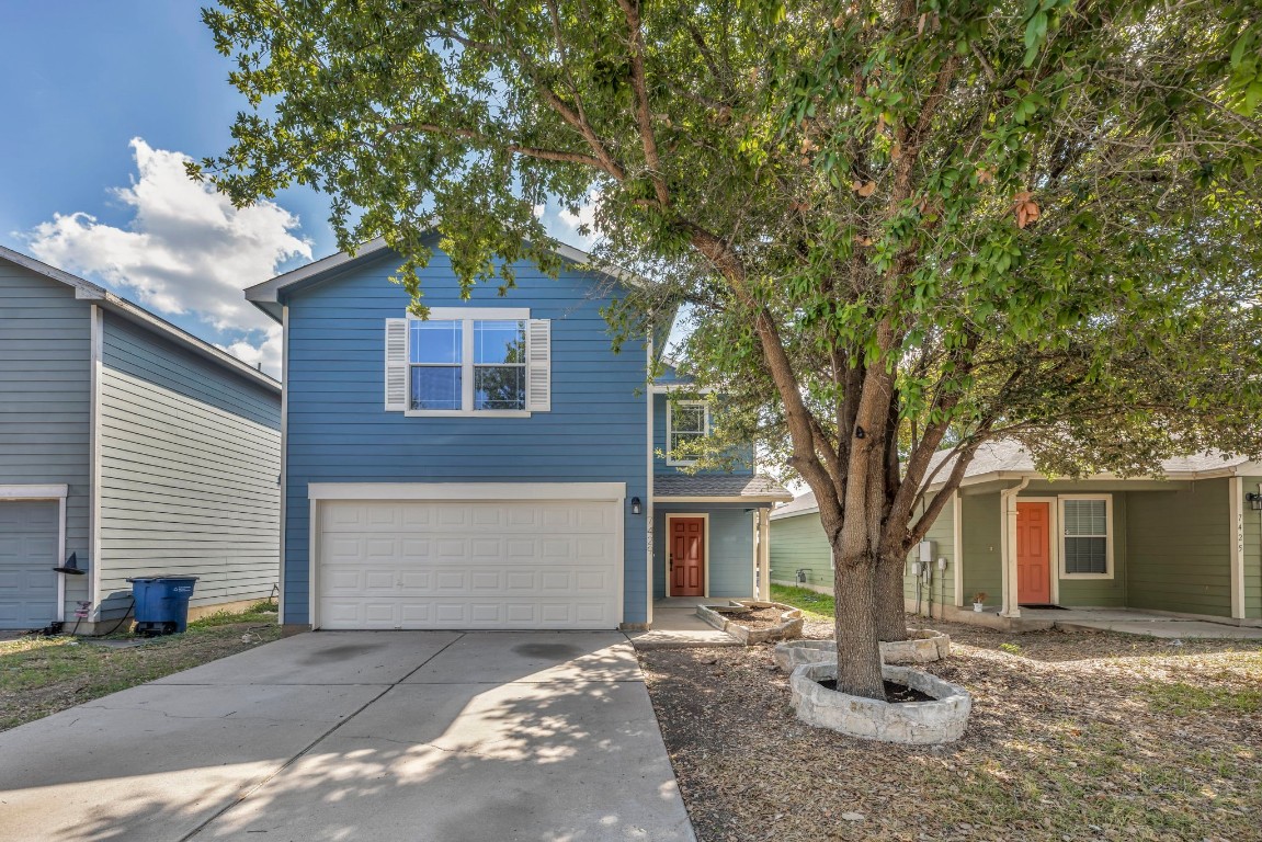 7429 Elk Pass Drive Austin, TX 78744 - Photo 1 of 1 a front view of a house with a tree