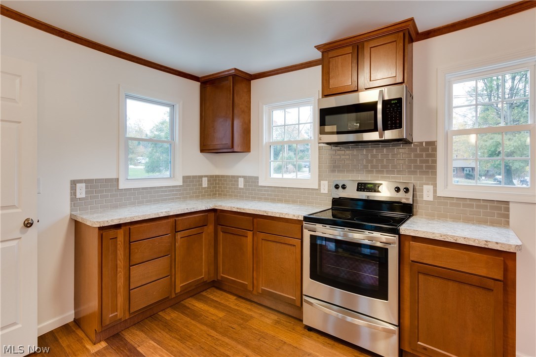 38705 Chardon Road Willoughby Hills, OH 44094 - Photo 6 of 35 Stainless Stove and Microwave - never used - as mentioned - tons of sunlight pours in from the new windows...another view of the subway tiles in modern gray....Kitchen laid out to work for YOU!