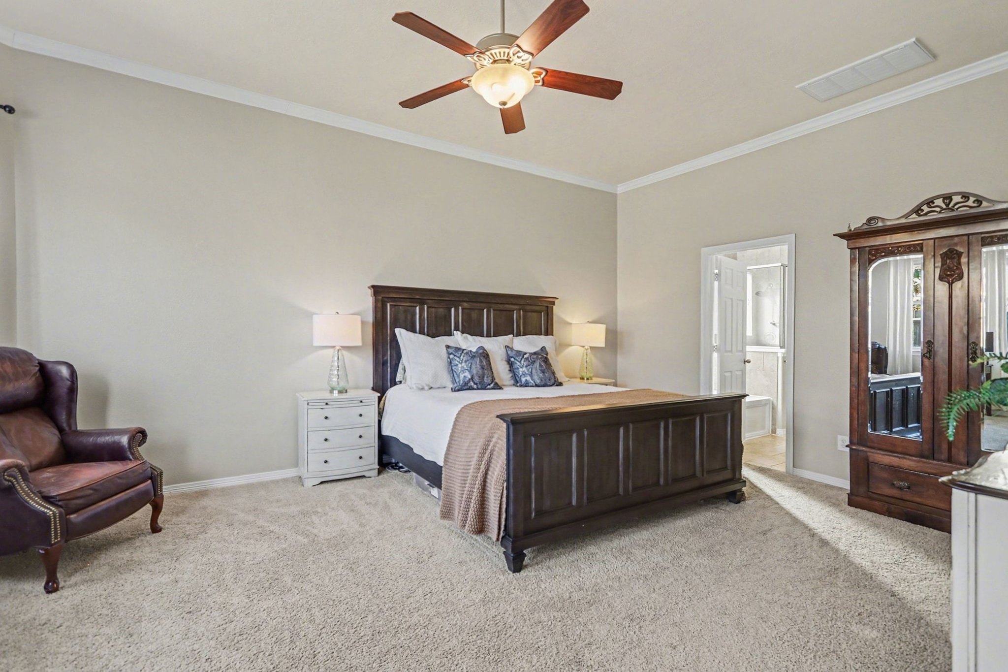 27006 Cliff Pointe Lane Katy, TX 77494 - Photo 18 of 34 Spacious primary suite featuring plush carpeting, crown molding, ceiling fan, and room to create a true personal retreat.