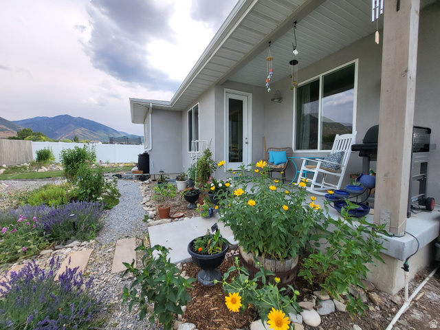 683 Kings Landing Tooele, UT 84074 - Photo 37 of 39 Covered concrete patio with a white ceiling and exposed wood support beam