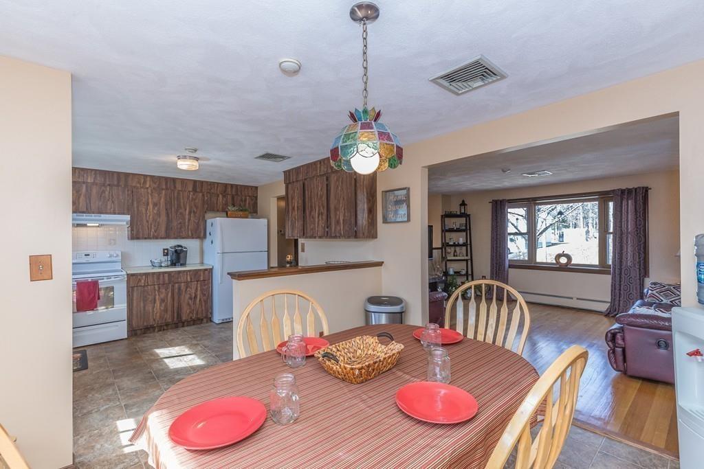21 Meadowvale Road Burlington, MA 01803 - Photo 8 of 30 a dinning room with stainless steel appliances furniture and wooden floor
