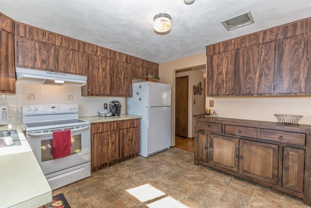 21 Meadowvale Road Burlington, MA 01803 - Photo 9 of 30 a kitchen with granite countertop a refrigerator stove top oven and cabinets