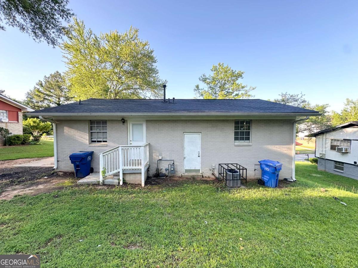 a view of a chair and table in backyard of the house