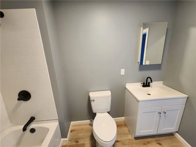 a bathroom with a sink a toilet and mirror