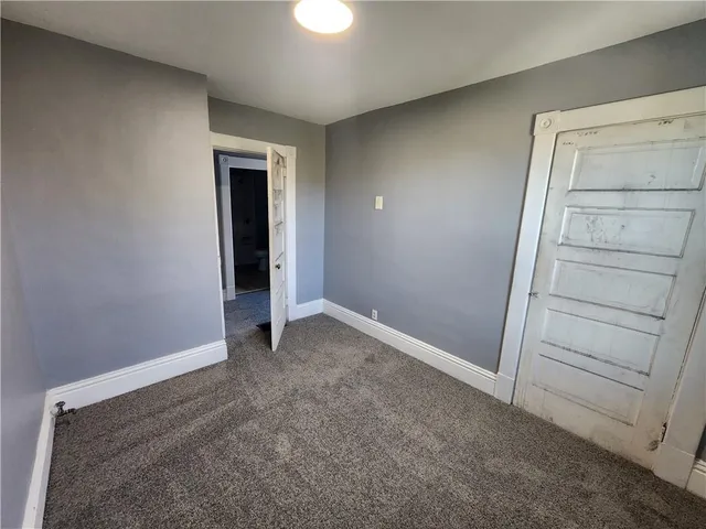 a view of an empty room and closet