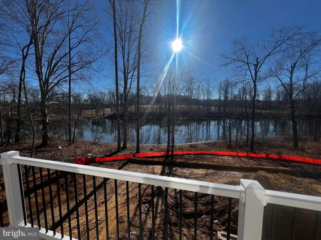 a street view with wooden fence and lake view