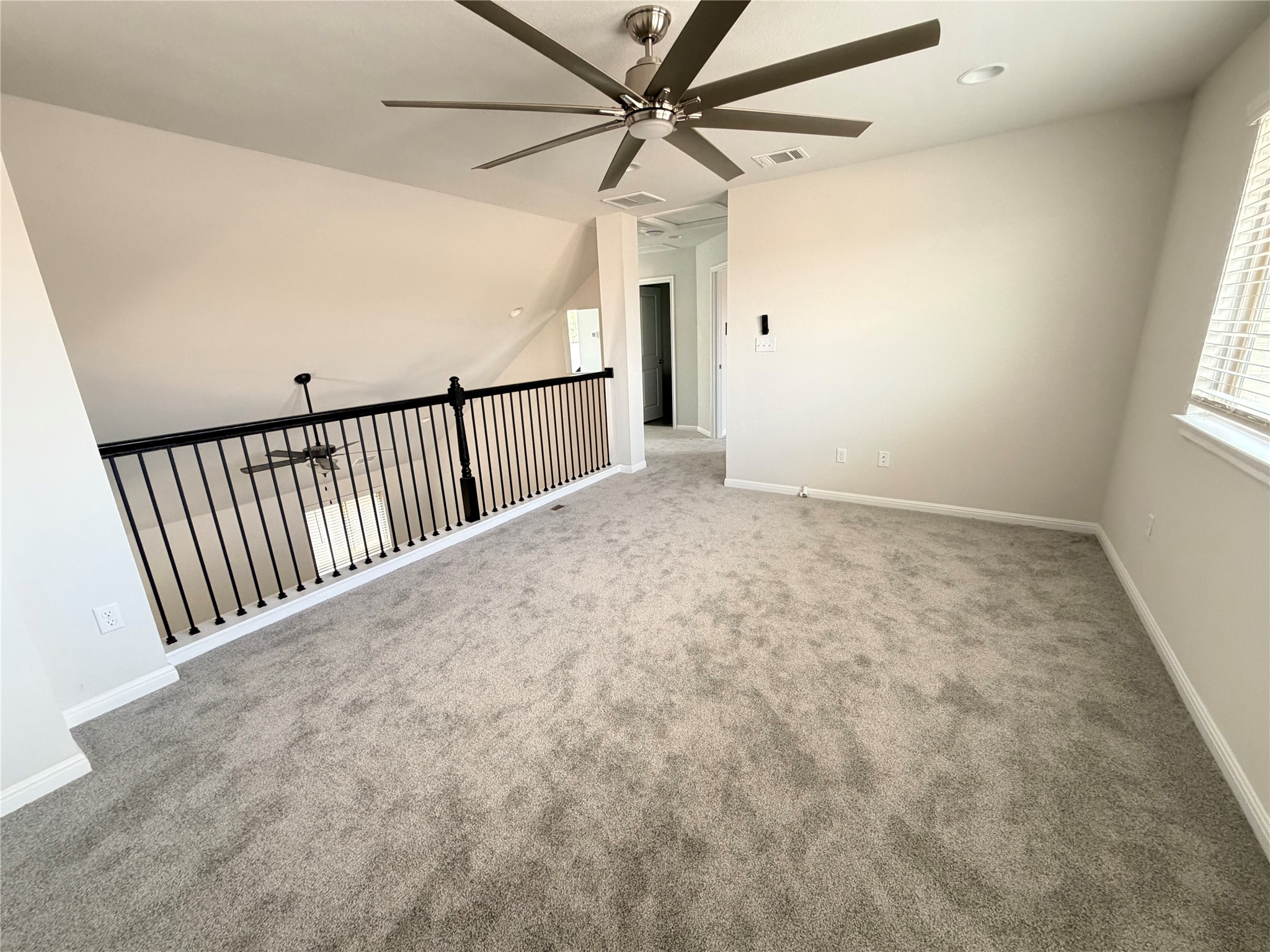 2813 Hopi Path, Unit 11 Leander, TX 78641 - Photo 11 of 17 Unfurnished room with ceiling fan, light carpet, and recessed lighting