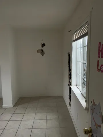 a view of a room with wooden floor and a sink