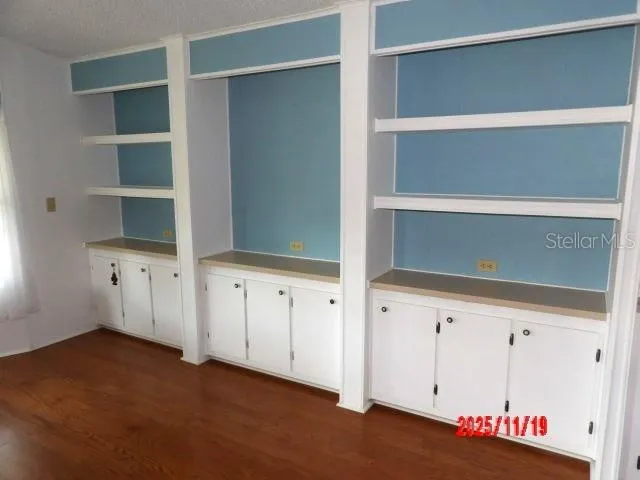 a kitchen with refrigerator and cabinets
