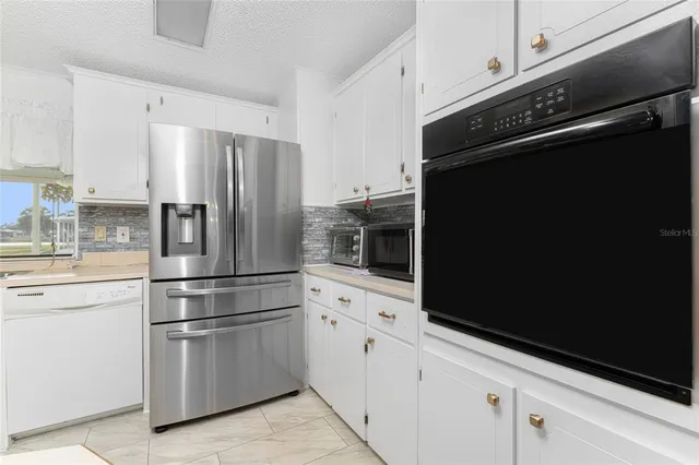 a spacious bathroom with a granite countertop sink a toilet and a mirror