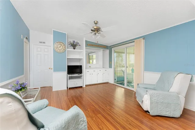 a living room with furniture and a floor to ceiling window