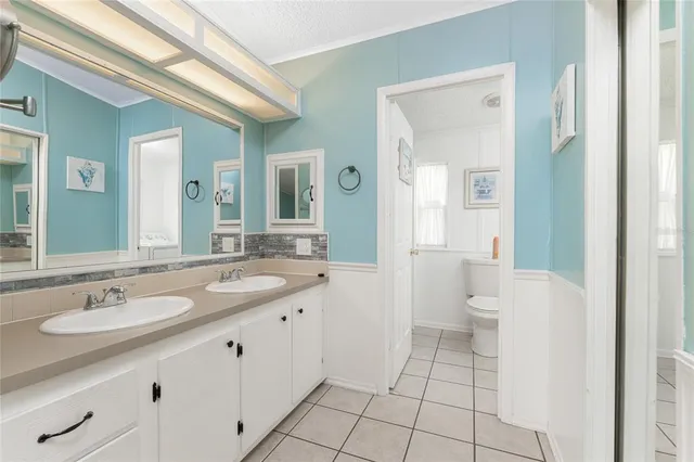 a bath room with a furniture and a large window