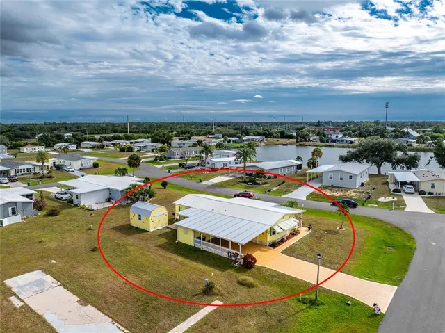 a dining room with furniture and a floor to ceiling window