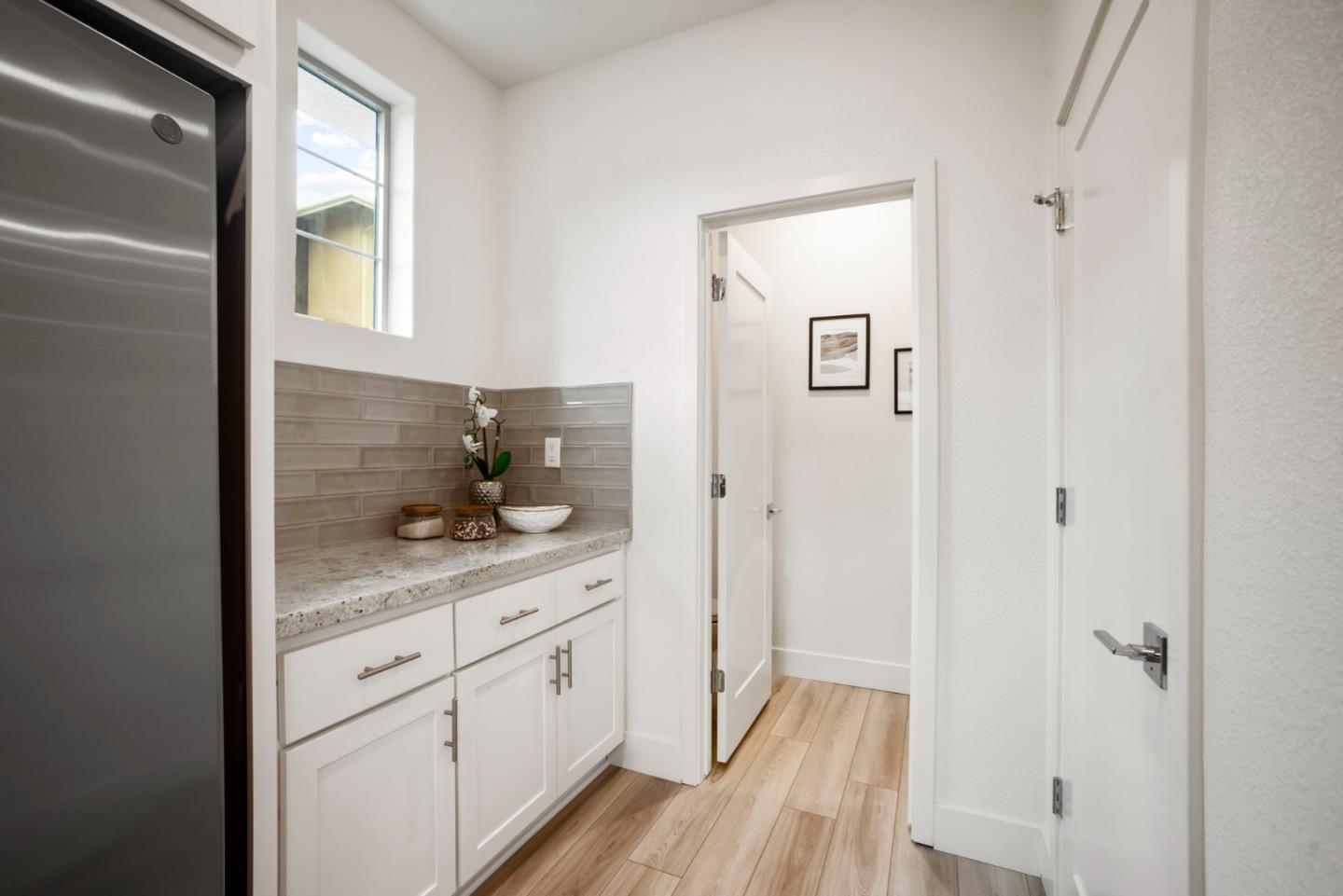 5720 Greige Circle, Unit G Dublin, CA 94568 - Photo 20 of 55 a hallway with white cabinets and wooden floor