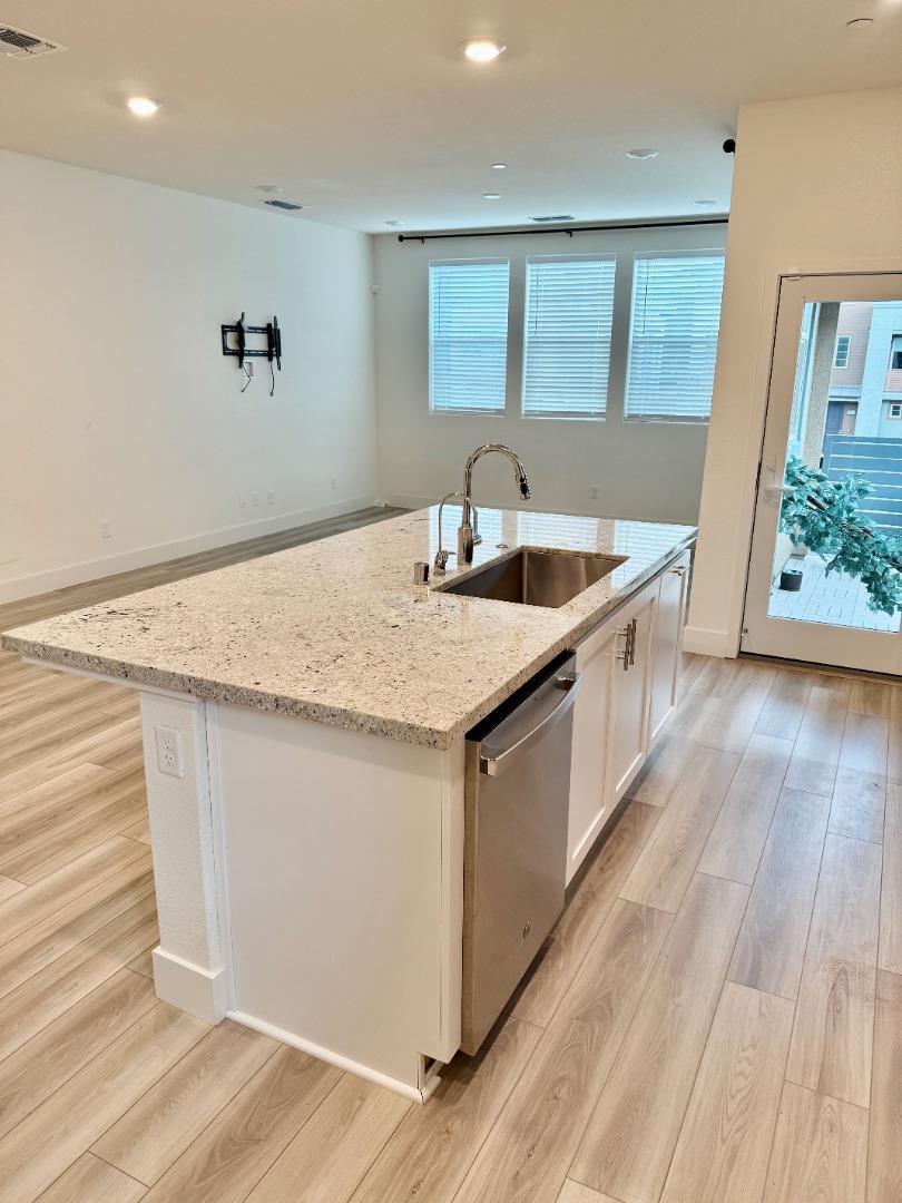 5720 Greige Circle, Unit G Dublin, CA 94568 - Photo 3 of 13 a kitchen that has a sink a stove and wooden floor
