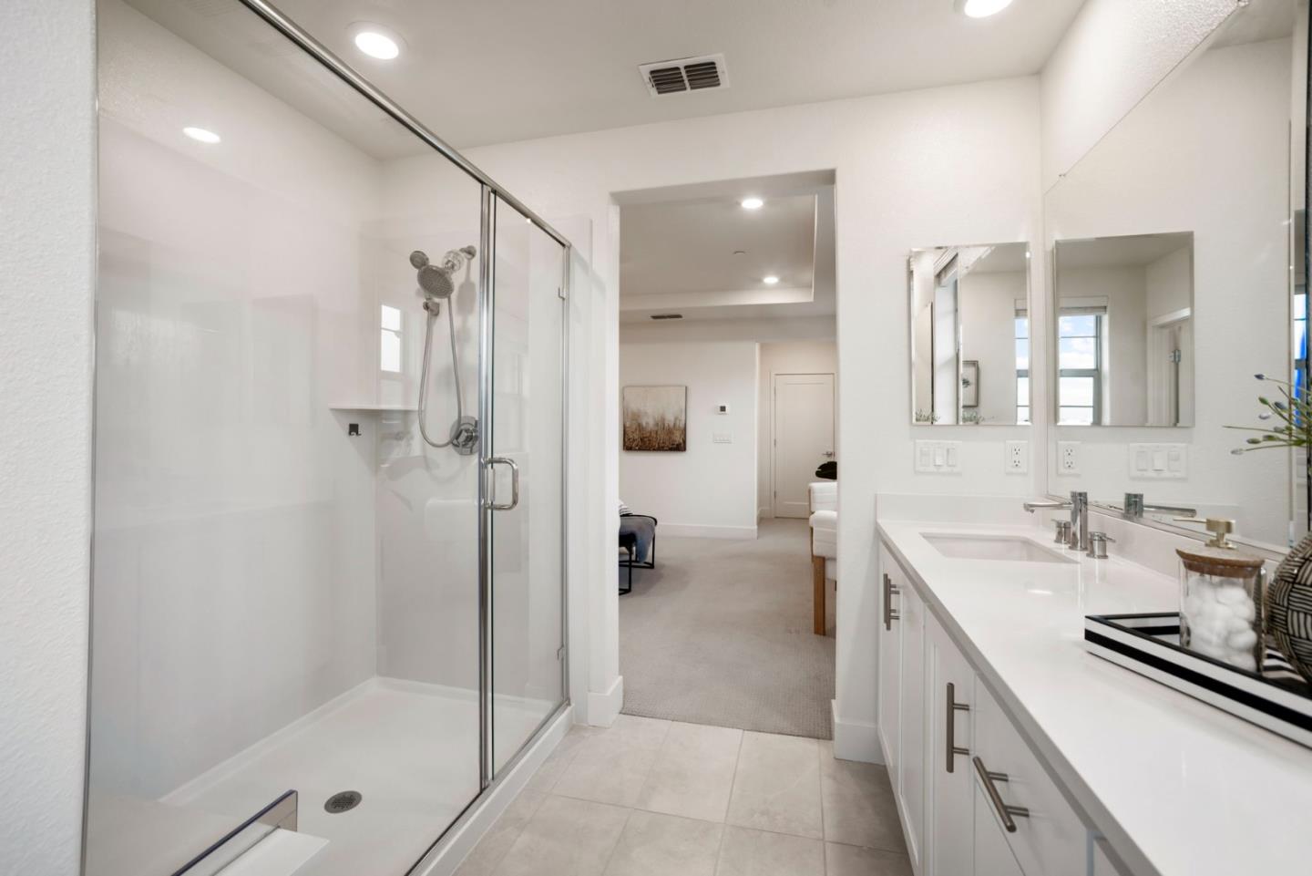 5720 Greige Circle, Unit G Dublin, CA 94568 - Photo 32 of 55 a bathroom with a shower sink and mirror