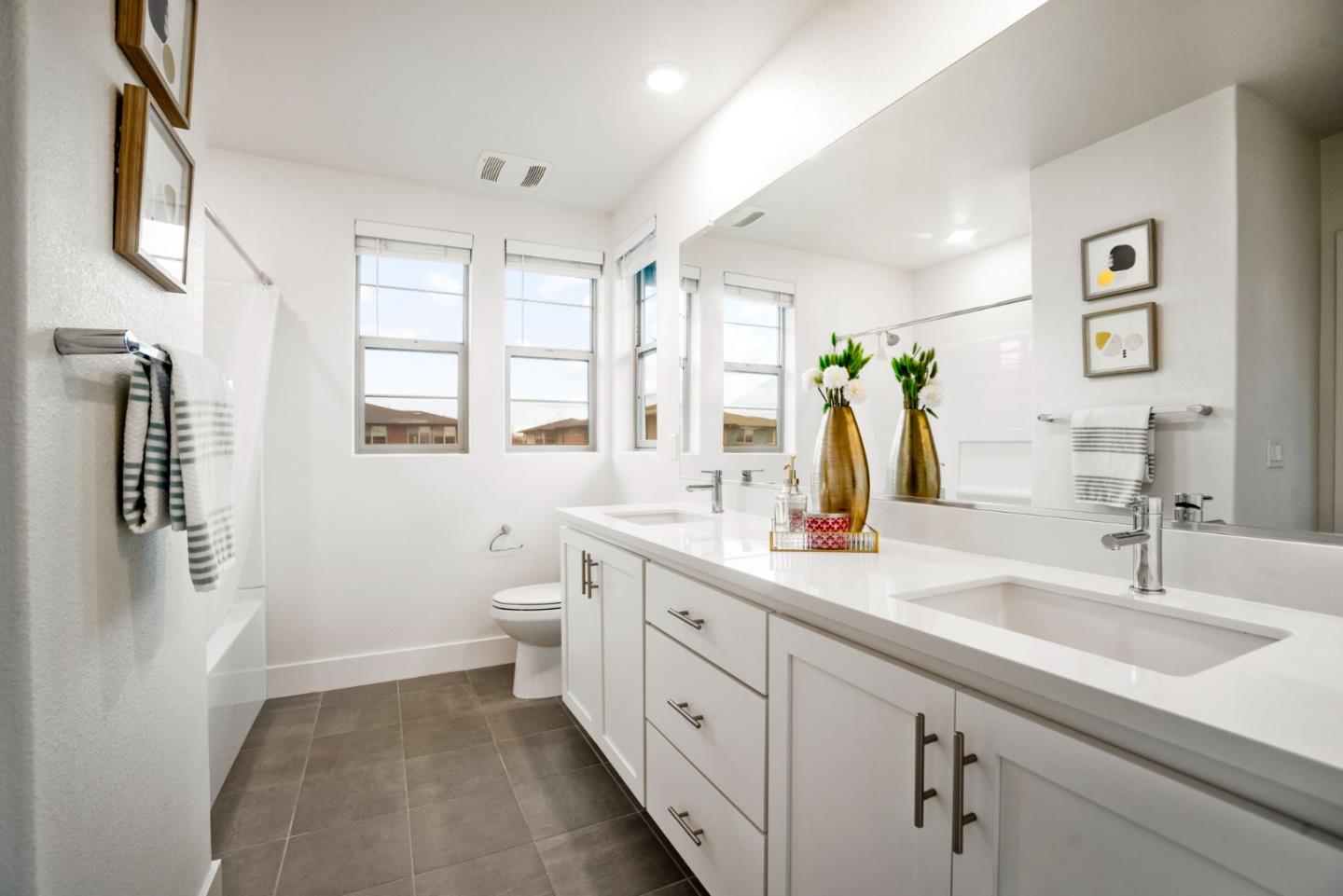 5720 Greige Circle, Unit G Dublin, CA 94568 - Photo 38 of 55 a bathroom with a double vanity sink toilet and a mirror