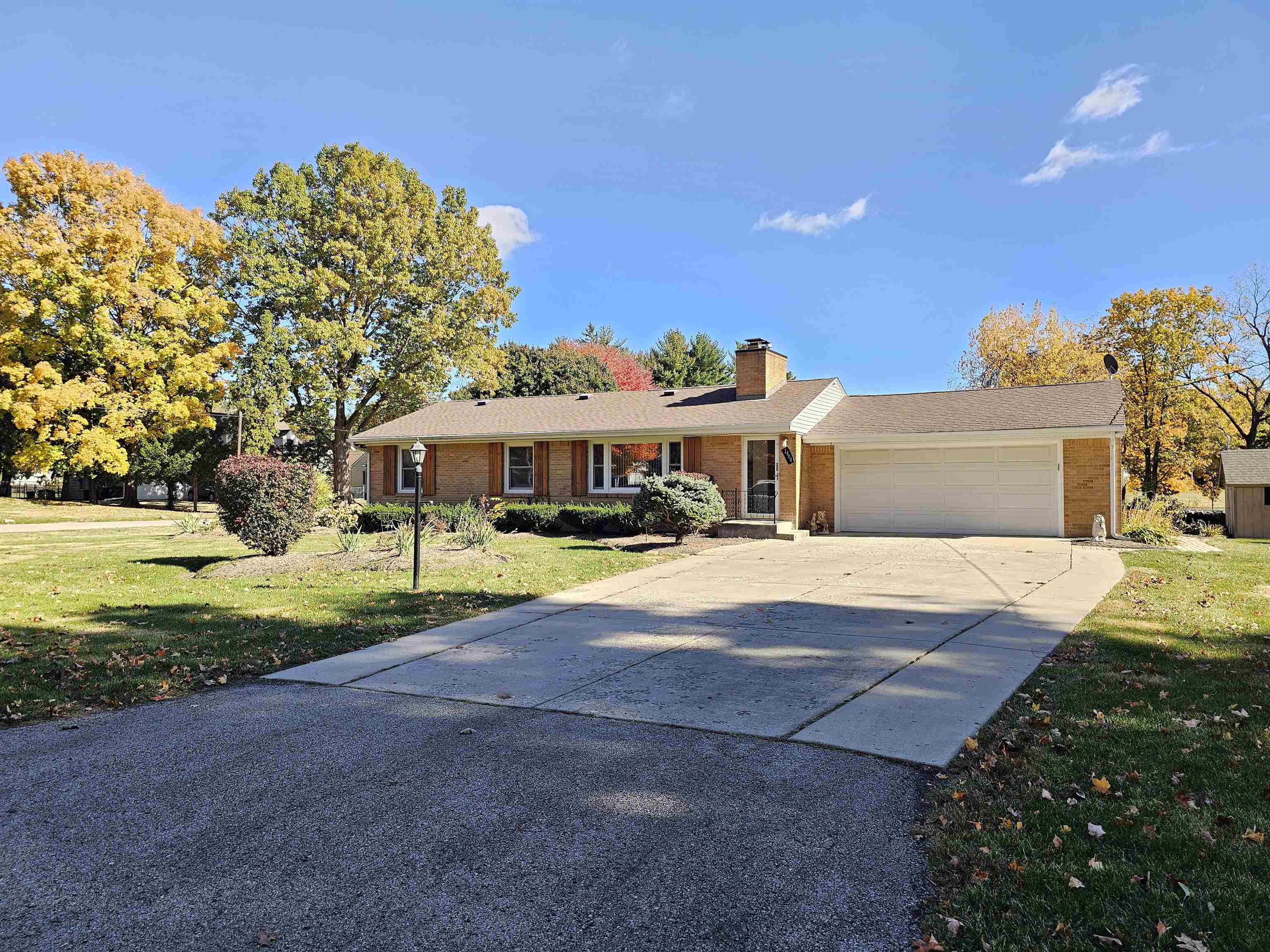 1404 Post Drive Rockford, IL 61108 - Photo 3 of 30 a front view of a house with a yard and garage
