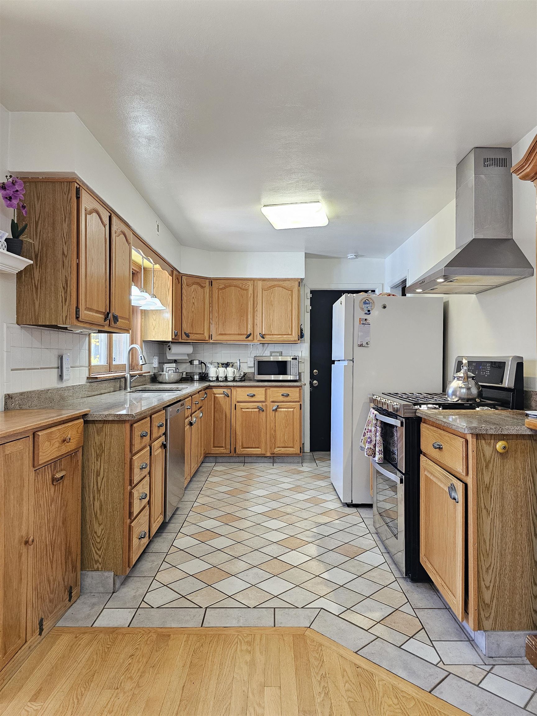 1404 Post Drive Rockford, IL 61108 - Photo 7 of 30 a large kitchen with stainless steel appliances granite countertop a stove a sink dishwasher and a refrigerator