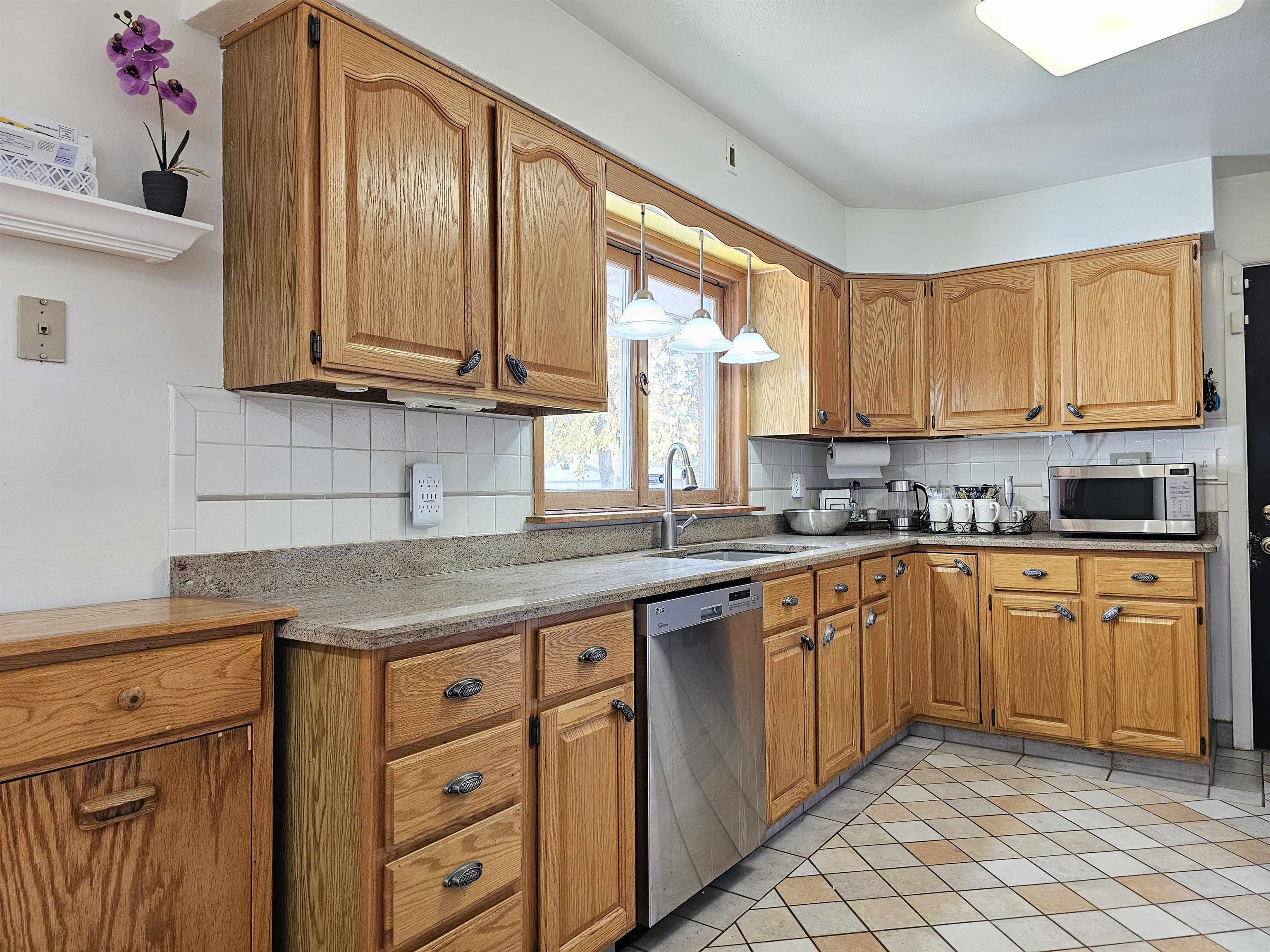 1404 Post Drive Rockford, IL 61108 - Photo 8 of 30 a kitchen with stainless steel appliances granite countertop a sink stove and cabinets