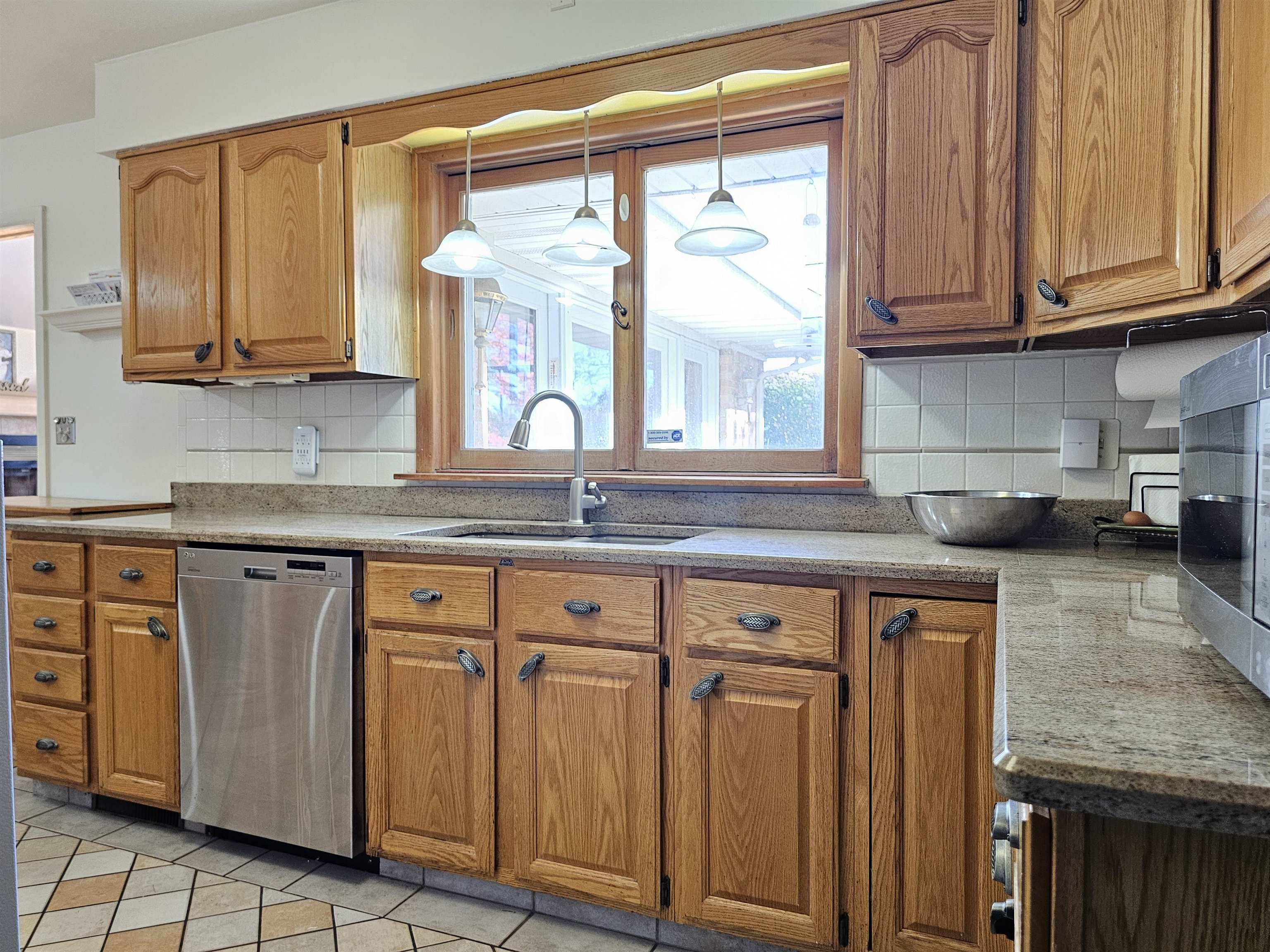 1404 Post Drive Rockford, IL 61108 - Photo 9 of 30 a kitchen with stainless steel appliances granite countertop a sink window and cabinets